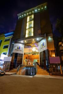 a building with stairs in front of it at night at Hotel Arafa Inn in Bangalore