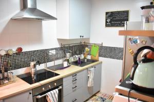 a small kitchen with a sink and a stove at La Pita Guesthouse in Almería