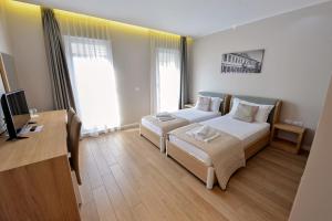 Łóżko lub łóżka w pokoju w obiekcie Alis Hotel