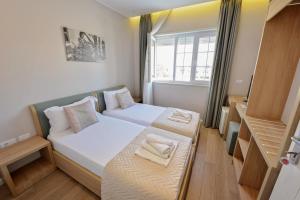 Łóżko lub łóżka w pokoju w obiekcie Alis Hotel