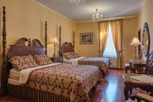 Postel nebo postele na pokoji v ubytování Hotel Royal