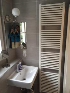 a bathroom with a sink and a mirror at Maison Riviére in Monschau