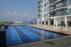 a large swimming pool in front of a building at One Residence Sekinchan 适耕庄无敌海景 in Sekinchan
