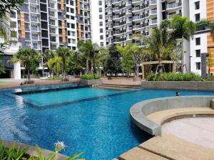 a swimming pool in a city with tall buildings at TimurBay Seafront Residence by HardinaHomes in Kuantan