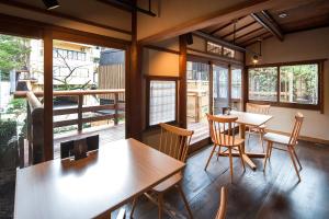 a room with tables and chairs and a balcony at KANSUIRO ANNEX in Hakone