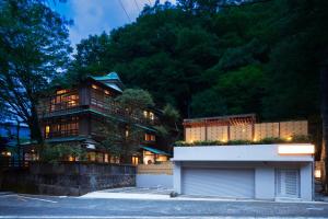 a large house with a garage in front of it at KANSUIRO ANNEX in Hakone