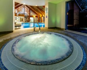 a hot tub in the middle of a room at Park Farm Hotel in Norwich