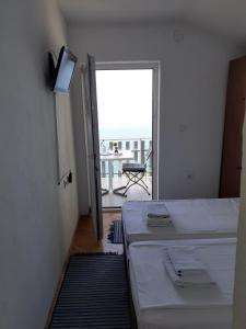 a room with a bed and a balcony with a view at Vila Idila in Ohrid