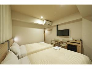 Postel nebo postele na pokoji v ubytování Sotetsu Fresa Inn Kamakura-Ofuna Higashiguchi