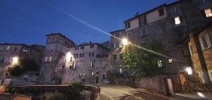 an empty street in an old city at night at Maison Mavù Perugia in Perugia