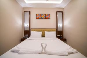 Postel nebo postele na pokoji v ubytování Hotel President
