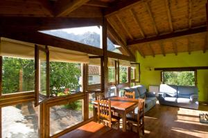 a living room with a table and a couch at Apartamentos Rurales Los Picos de Redo in Camaleño