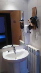 a bathroom with a sink and a mirror at El Albergue Covaleda in Covaleda