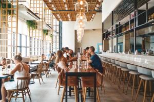 a group of people sitting at tables in a restaurant at Lub d Philippines Makati in Manila