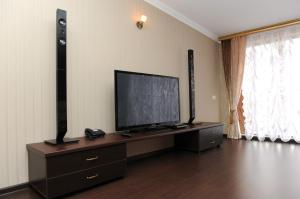 una sala de estar con TV de pantalla plana en una cómoda en Hotel Mona Lisa, en Nizhny Novgorod