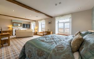 a bedroom with a bed and a living room at The Inn at Ravenglass in Ravenglass
