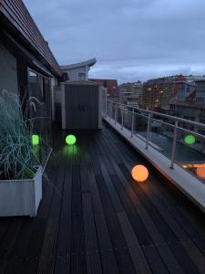 a balcony with lights on the deck of a building at Cap Nord 501 in Nieuwpoort