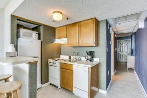 a kitchen with wooden cabinets and white appliances at Spectacular Oceanview Condos in Myrtle Beach +214 photos
