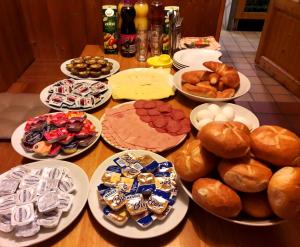 a table full of different types of bread and pastries at Pension Mois in Wurz