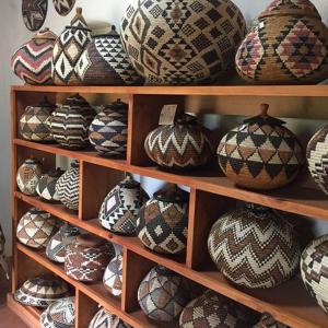 a shelf filled with lots of decorated vases at Hluhluwe Country cottages in Hluhluwe