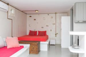 a bedroom with two beds with red pillows at Villa Mousa in Mikri Vigla