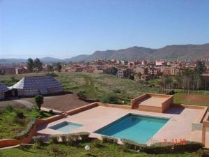 an overhead view of a swimming pool with a city at HOTEL CONTINENTAL Khénifra in Khenifra