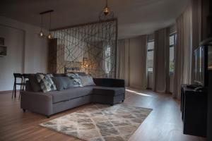 a living room with a couch and a rug at Redondo Loft in Macedo de Cavaleiros