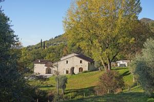 an old house on a hill with a tree at Premignaga Natural Home in Gardone Riviera