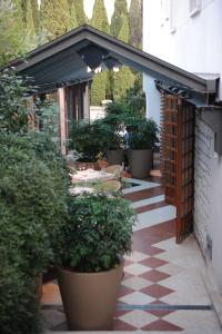 a patio with potted plants and an awning at Hotel Milan in Pula