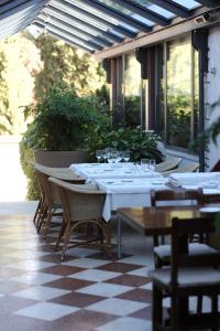 a table with wine glasses sitting on a patio at Hotel Milan in Pula