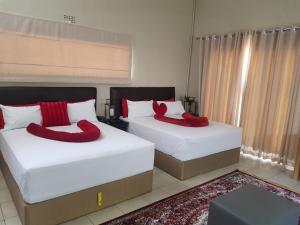 Ένα ή περισσότερα κρεβάτια σε δωμάτιο στο ALIMOP GUESTHOUSE