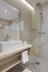 uma casa de banho com um lavatório e um chuveiro em Hotel Gardenazza em Badia
