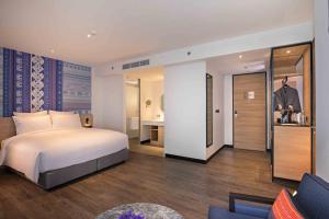 Novotel Chiangmai Nimman Journeyhub客房内的一张或多张床位