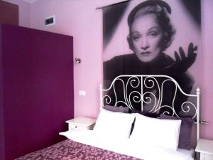 a bedroom with a poster of a woman on the wall at Apartamenty Lili & Country in Krakow