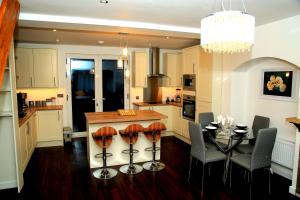 a kitchen with a table and a dining room at A Modern, Comfy Newly Remodeled 2bd House in Barking