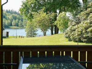 a view of a lake from the deck of a house at 6 person holiday home in ULLARED in Ullared