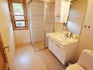 a bathroom with a toilet and a sink and a shower at 10 person holiday home in tvedestrand-By Traum in Tvedestrand