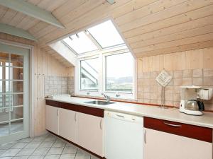 uma cozinha com um lavatório e uma janela em 6 person holiday home in Ringk bing em Søndervig