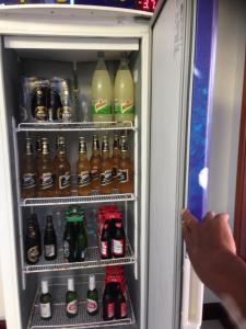 a refrigerator filled with lots of bottles of soda at Hangaroa in Bertioga