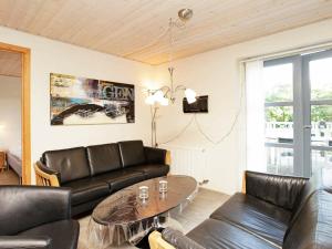 a living room with a couch and a table at 12 person holiday home in H jslev in Bøstrup