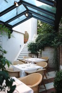 an outdoor patio with tables and chairs and stairs at Hotel Milan in Pula