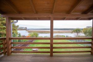 a view from the porch of a cabin with a view of a river at Apartament Czarna Wieś in Rajgród