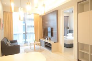 a hotel room with a bed and a television at The Robertson by KL MoonLight Suites Bukit Bintang in Kuala Lumpur