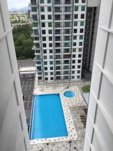 an overhead view of a large building with a swimming pool at Lvl 22 City Park View 3BR Full Aircond with Pool at Casa Kayangan Meru in Ipoh