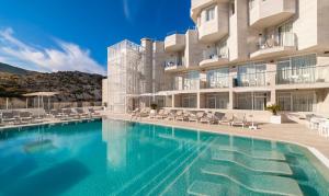 a large swimming pool in front of a building at Globales Don Pedro - Adults Only in Cala de Sant Vicenc