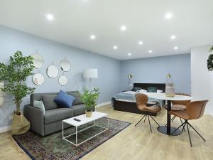uma sala de estar com um sofá, uma mesa e uma cama em Rent a Room - Residence Caire, Montorgueil em Paris