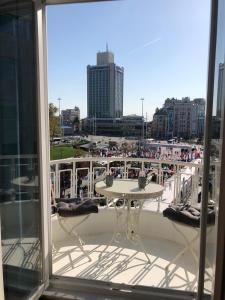 a balcony with a table and a view of a city at Great View of Taksim Square, Luxury Furnished on Main Street of Taksim, Partial Sea View in Istanbul