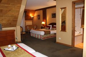 Postel nebo postele na pokoji v ubytování Hotel Le Mandelberg