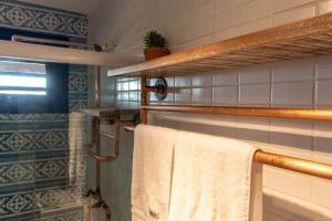 a bathroom with a towel hanging on a towel rack at Casa Corveta in São Miguel do Gostoso +40 photos