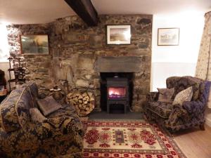 a living room filled with furniture and a fire place at Aber Cottage B&B in Dolgellau